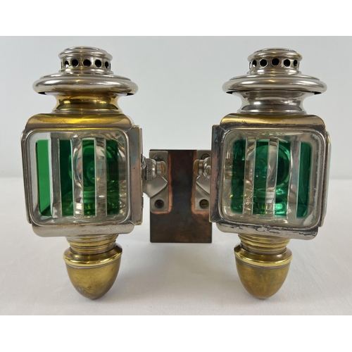 1213 - A pair of early 20th century French acetylene car lamps with green striped lenses. Mounted onto a co...