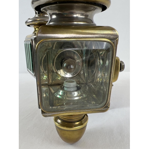 1213 - A pair of early 20th century French acetylene car lamps with green striped lenses. Mounted onto a co... 