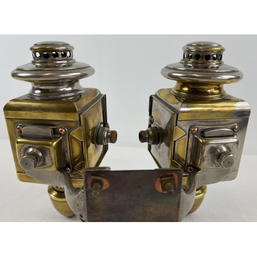 1213 - A pair of early 20th century French acetylene car lamps with green striped lenses. Mounted onto a co... 