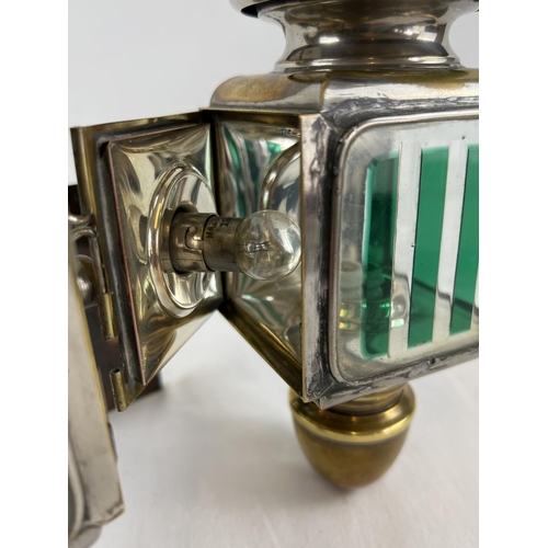 1213 - A pair of early 20th century French acetylene car lamps with green striped lenses. Mounted onto a co... 