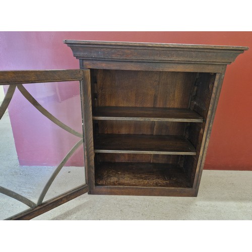 1317 - An antique dark oak, glass fronted wall cabinet with decorative carved panel sides. 2 adjustable int... 