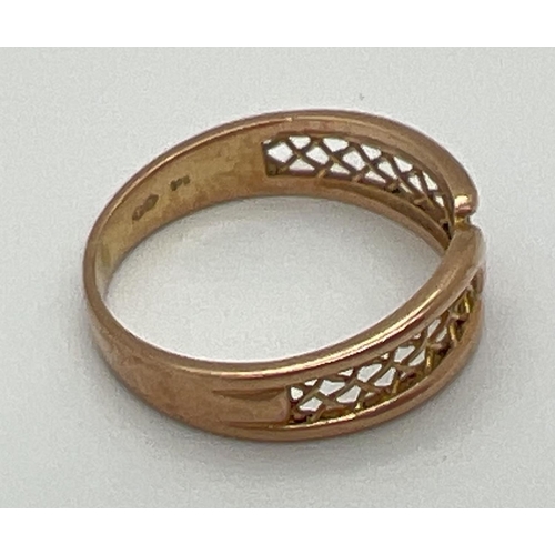 1100 - A vintage 9ct yellow gold band style ring with pierced panel detail of criss-cross design. Fully hal... 