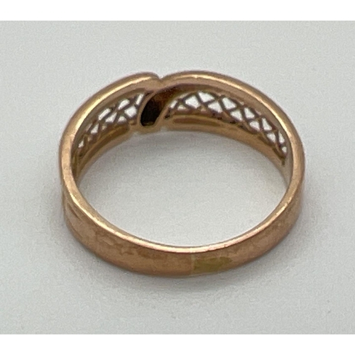 1100 - A vintage 9ct yellow gold band style ring with pierced panel detail of criss-cross design. Fully hal... 