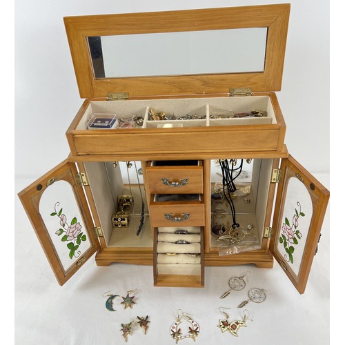 1097 - A wooden jewellery cabinet with a quantity of assorted vintage costume jewellery. To include earring... 