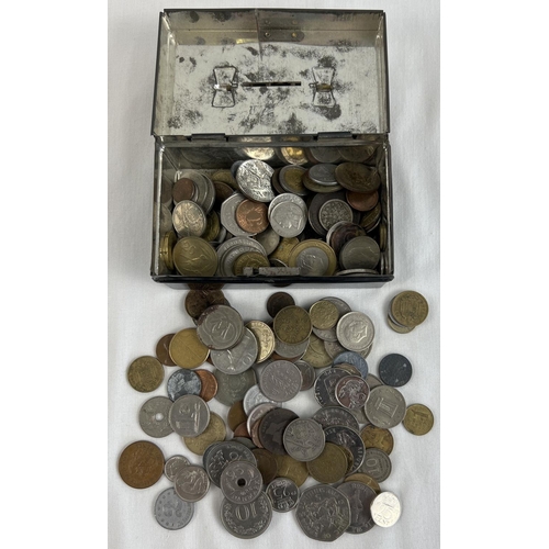 24 - A small vintage black painted cash tin, with key, containing a collection of foreign coins. To inclu... 