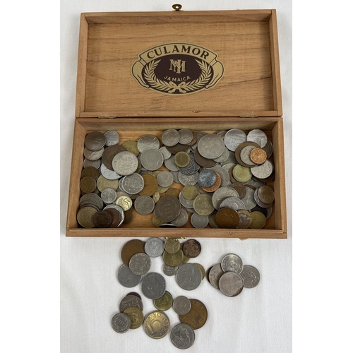 25 - A wooden cigar box containing a collection of vintage foreign coins. To include examples from Kenya,... 