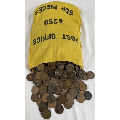 27 - A large collection of antique and vintage one penny coins in a yellow cloth money bag. Sovereign hea... 