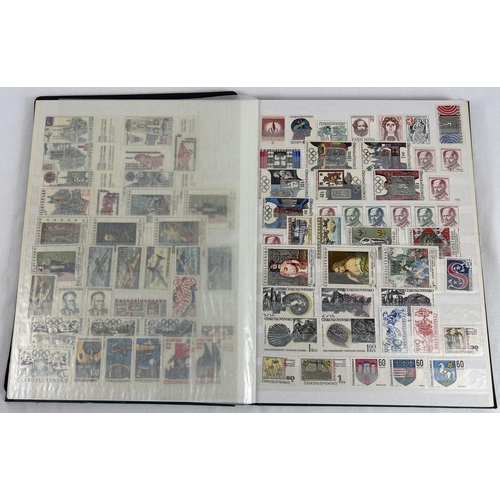 126 - A green vintage stamp album containing a collection of unused world stamps together with loose sheet... 