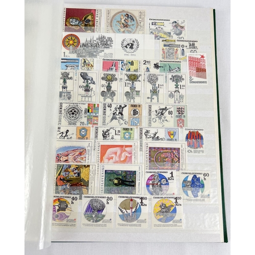 126 - A green vintage stamp album containing a collection of unused world stamps together with loose sheet... 