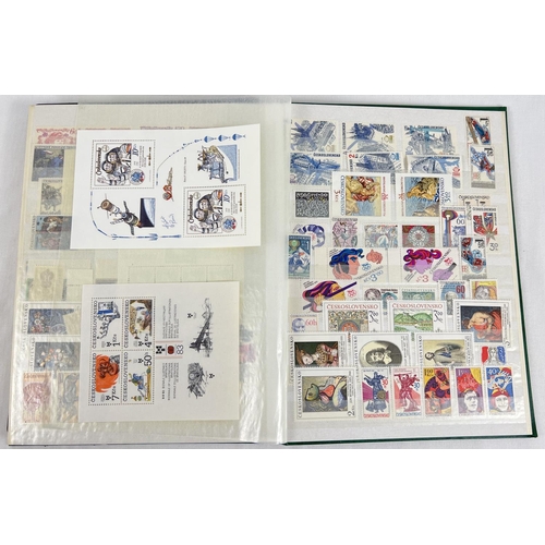 126 - A green vintage stamp album containing a collection of unused world stamps together with loose sheet... 