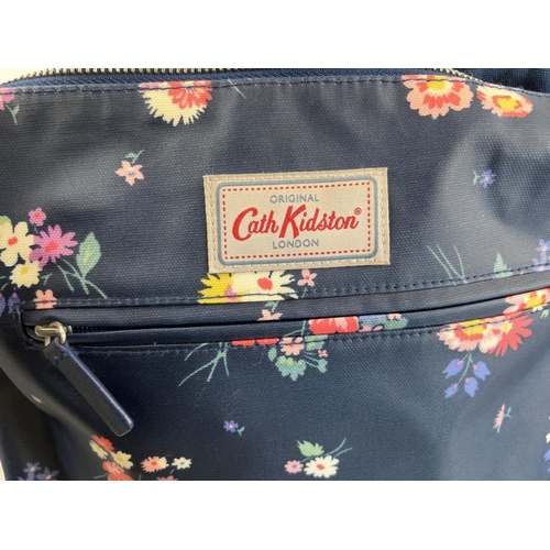 1324 - 3 designer handbags by Cath Kidston. A navy floral over the body bag with canvas strap, a floral des... 