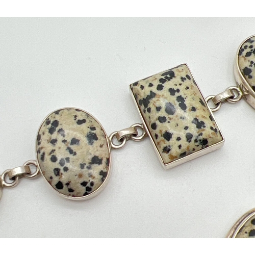 1005 - A modern design silver bracelet and  matching pendant, set with Dalmatian jasper. Bracelet approx. 7... 