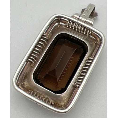 1008 - A large rectangular Art Deco style continental silver pendant set with an emerald cut smoked quartz ... 