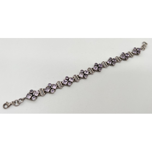 1056 - A modern design silver and amethyst bracelet with lobster clasp. 8 links all set with 2 square cut a... 