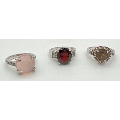 1066 - 3 silver stone set dress rings All by The Genuine Gem Company. A central oval cut garnet with small ... 