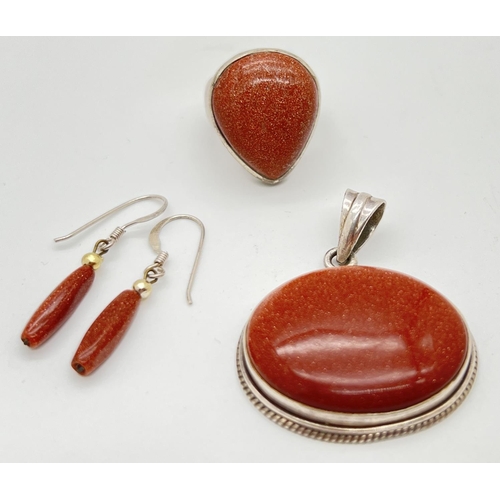 1070 - 3 pieces of copper goldstone jewellery all set in white metal or silver. A oval pendant in bead work... 