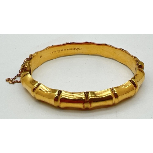 1076 - A vintage bamboo shaped 1/5th 9ct rolled gold bangle with push clasp and safety chain. Engraved deta... 