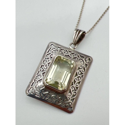 1082 - A large square shaped silver pendant set with a emerald cut lemon quartz stone. Pierced scroll work ... 