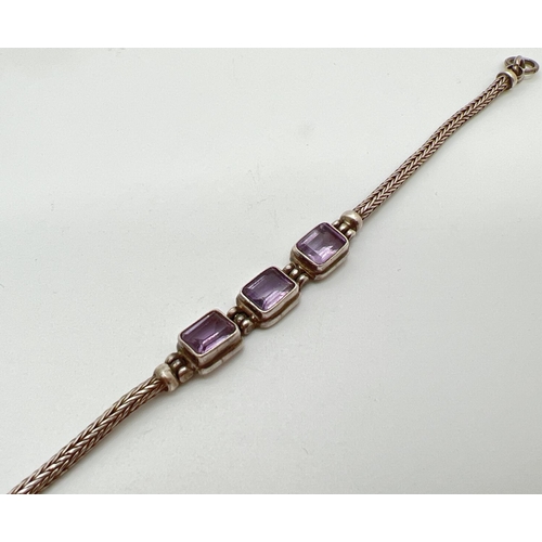 1083 - A modern design silver foxes tail chain bracelet set with 3 emerald cut amethysts and lobster style ... 