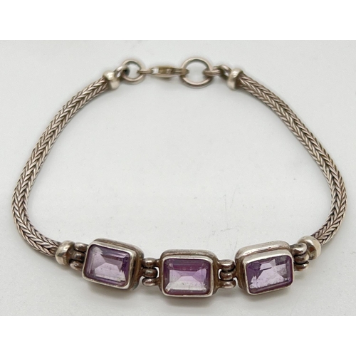 1083 - A modern design silver foxes tail chain bracelet set with 3 emerald cut amethysts and lobster style ... 