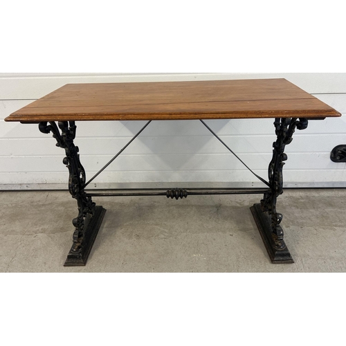 1351 - A wooden topped table with cast iron base, obtained from a public house after refurbishment. Painted... 