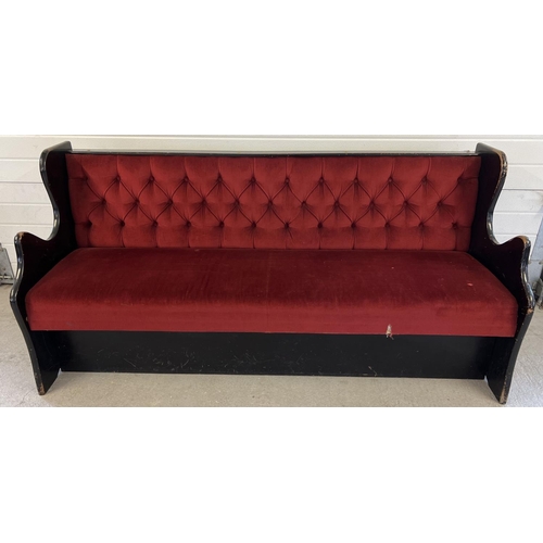 1359 - A vintage wooden bench seat painted black with button backed red velour upholstery and shaped ends. ... 