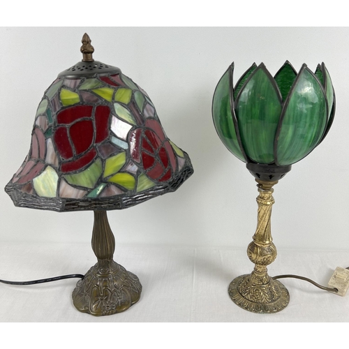 1340 - 2 metal based Tiffany style table lamps with leaded coloured glass shades. A gilt based lamp with gr... 