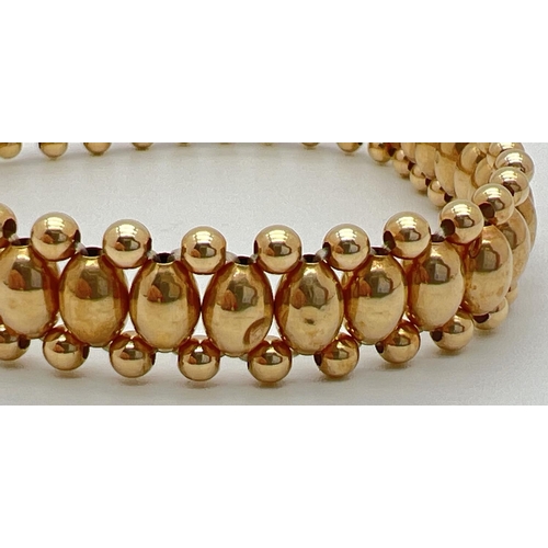 25 - A 14ct gold oval and round bead elasticated bracelet, approx. 7 inches long. Total weight approx. 3.... 