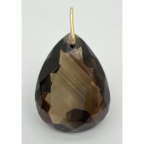 94 - A large, faceted teardrop cut smoked quartz stone pendant on a 14ct gold hanging bale. Pendant appro... 