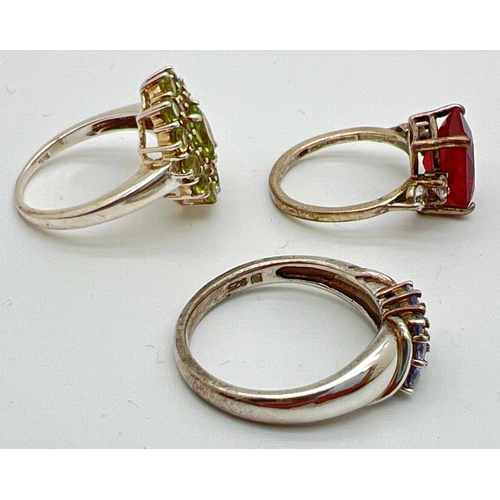 47 - 3 silver stone set dress/cocktail rings. A square cut red spinel with two round cut clear stones to ... 