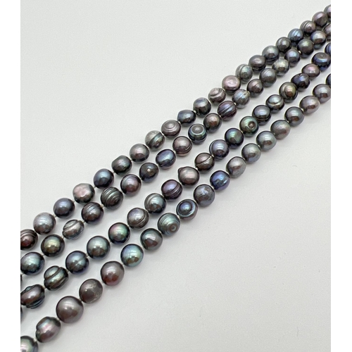 48 - A 31 inch string of knotted AA peacock pearls with varying rainbow hues.