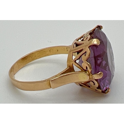 2 - An 18k Egyptian gold dress ring set with a large round cut purple amethyst. Pierced heart detail to ... 