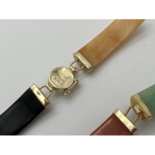 106 - A 14k gold and multi coloured jade bracelet with Chinese character detail to clasp. Two jade panels ... 