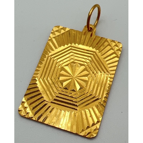 55 - A 22ct gold large square pendant with oriental design dragon to front and geometric sun ray design t... 