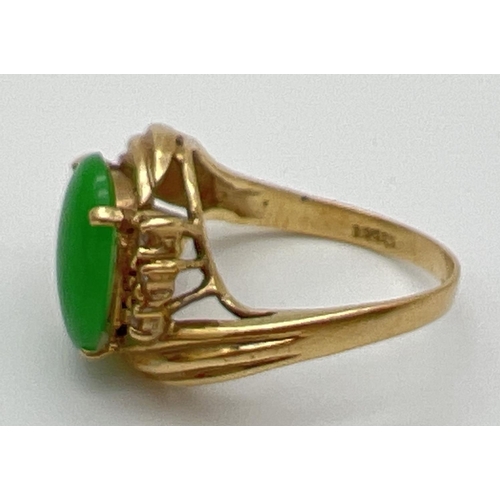 56 - A vintage 14ct gold jade and diamond set dress ring. A twist design mount set with an oval cabochon ... 