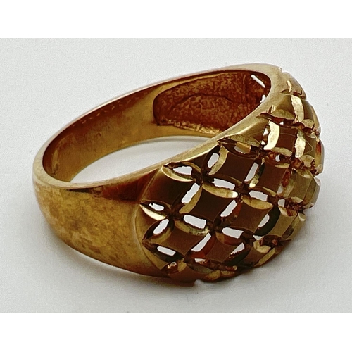 57 - A 9ct gold dome style dress ring with pierced work lattice design to top. Full hallmarks to inside o... 