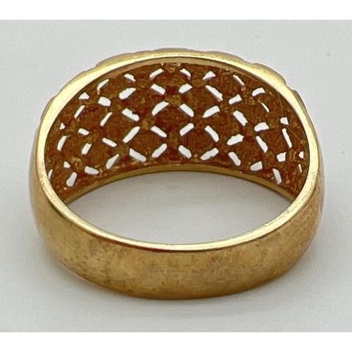 57 - A 9ct gold dome style dress ring with pierced work lattice design to top. Full hallmarks to inside o... 