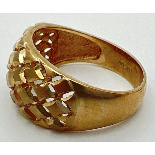 57 - A 9ct gold dome style dress ring with pierced work lattice design to top. Full hallmarks to inside o... 