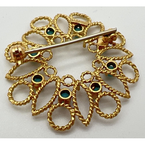 7 - A 18ct gold open work circular brooch set with 8 small round turquoise cabochons. Secure pin to back... 