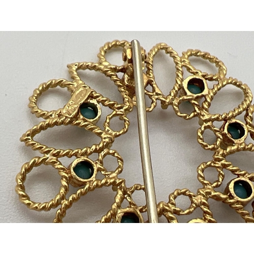 7 - A 18ct gold open work circular brooch set with 8 small round turquoise cabochons. Secure pin to back... 