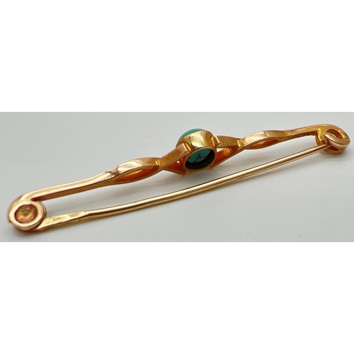 23 - A 15ct gold twist design bar brooch set with a central turquoise cabochon. Marked 15ct to back with ... 