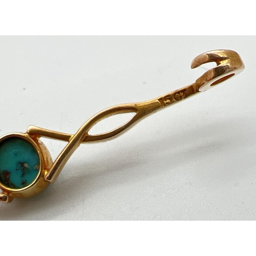 23 - A 15ct gold twist design bar brooch set with a central turquoise cabochon. Marked 15ct to back with ... 