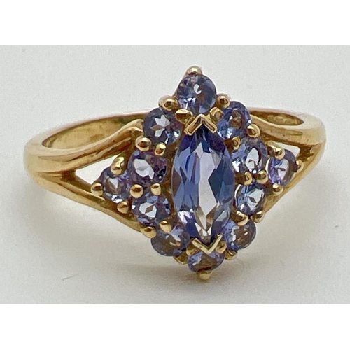 68 - A 9ct gold and Iolite stone set dress ring. A central marquise cut Iolite stone surrounded by 12 rou... 