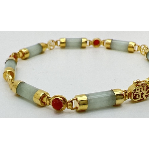 73 - A 7.5 inch 14k gold, green and orange jade bracelet. 8 small barrel beads of green jade with alterna... 