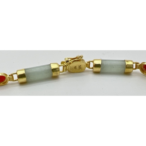 73 - A 7.5 inch 14k gold, green and orange jade bracelet. 8 small barrel beads of green jade with alterna... 