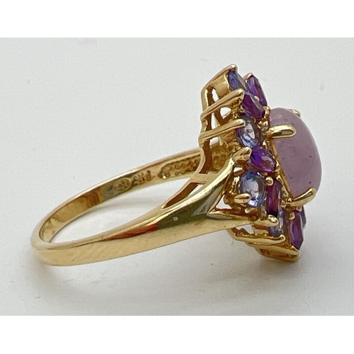 9 - A 14K gold dress ring set with lavender jade, Iolite and amethyst stones. Central oval cabochon of j... 