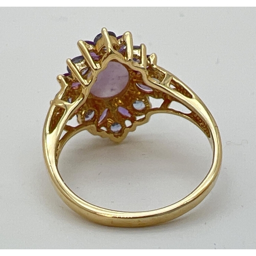 9 - A 14K gold dress ring set with lavender jade, Iolite and amethyst stones. Central oval cabochon of j... 