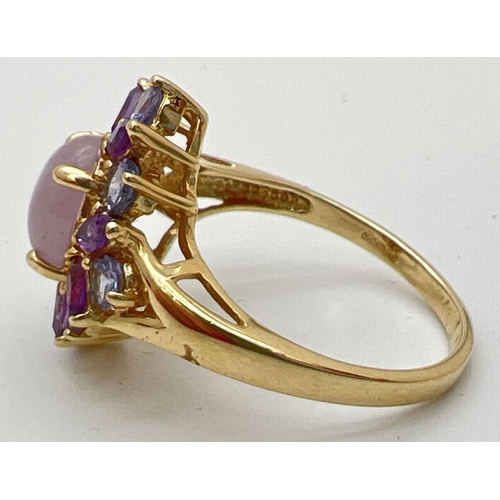 9 - A 14K gold dress ring set with lavender jade, Iolite and amethyst stones. Central oval cabochon of j... 