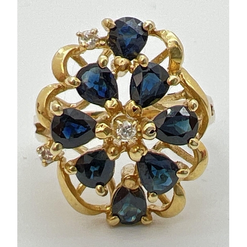 77 - A 14k gold large open design mount dress ring set with sapphires and diamonds. 8 teardrop cut midnig... 