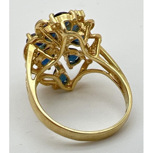 77 - A 14k gold large open design mount dress ring set with sapphires and diamonds. 8 teardrop cut midnig... 